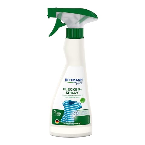 Flacon jaune de spray détachant végétal posé sur du lin écru dans une buanderie sobre
